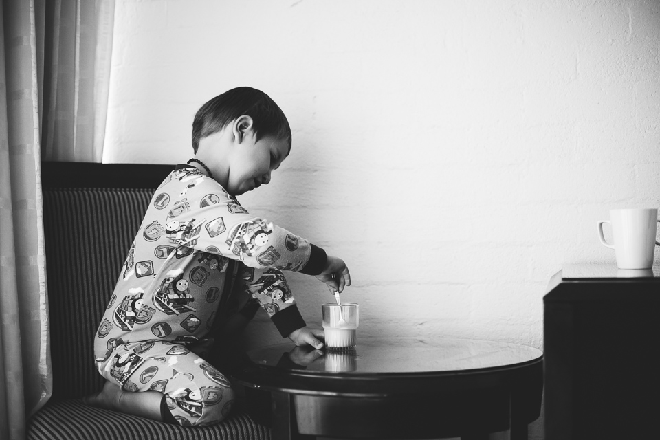 Black and White little boy eating snack - Family Documentary photography