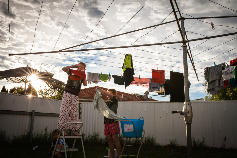 Kids hanging up laundry  - Family Documentary Photography