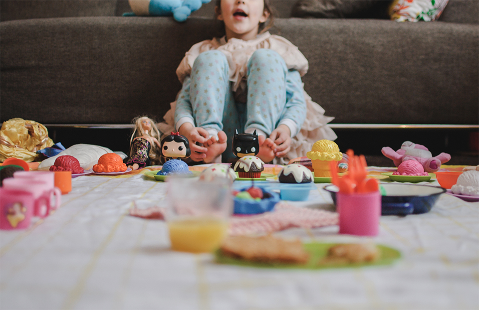 Little girl watches TV with toys - Family Documentary Photography