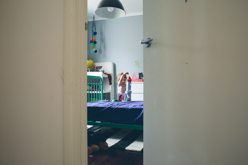 child playing alone in bedroom - family documentary photography