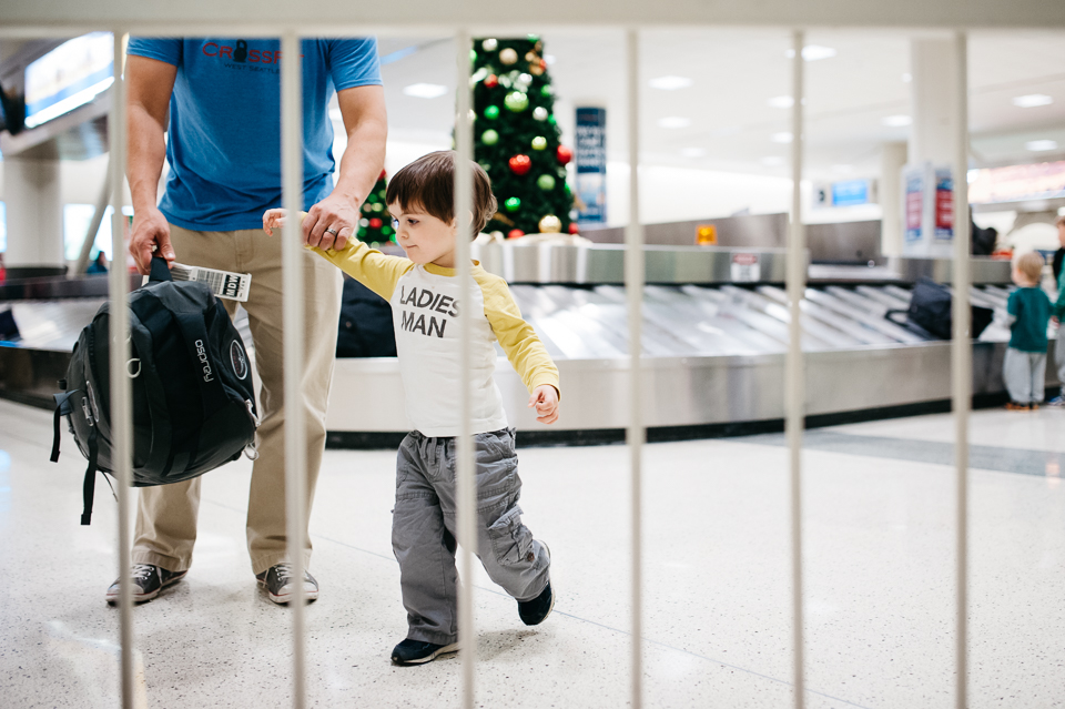 Family Documentary Photography - Little boy with dad at baggage claim