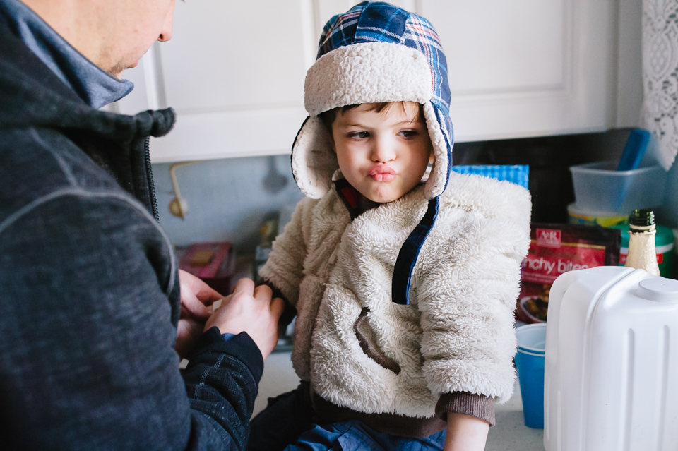 Little boy in winter hat pouts - Family Documentary Photography