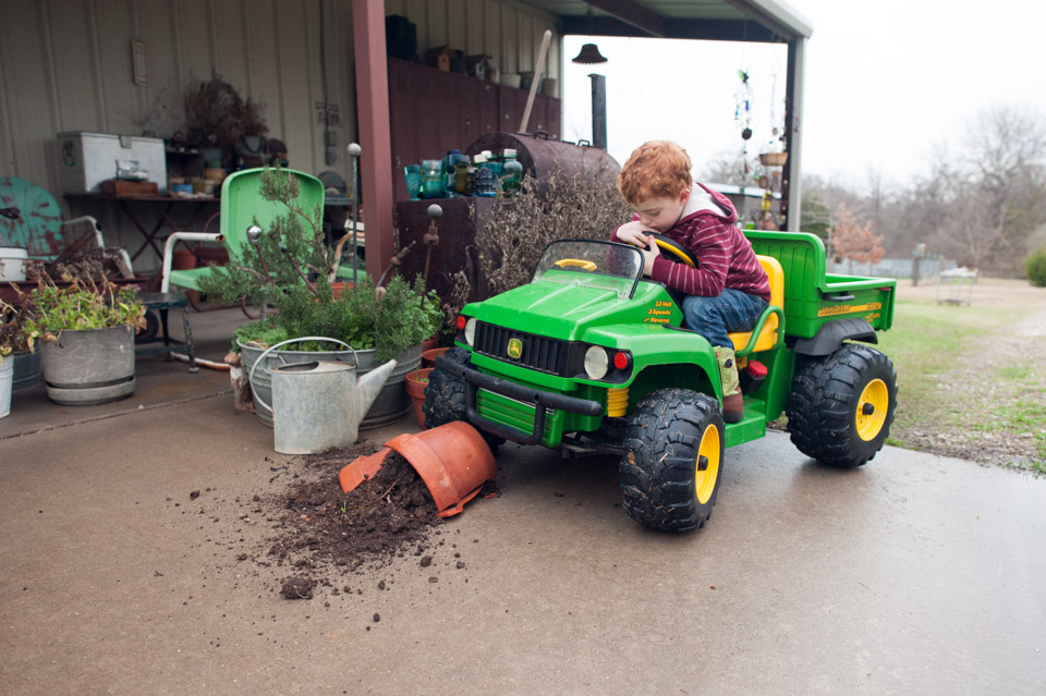 Family Documentary Photography - Little boy runs over planter in John Deere