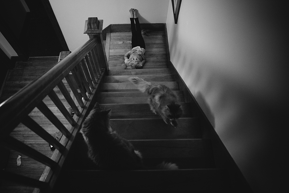 girl laying on stairs - family documentary photography