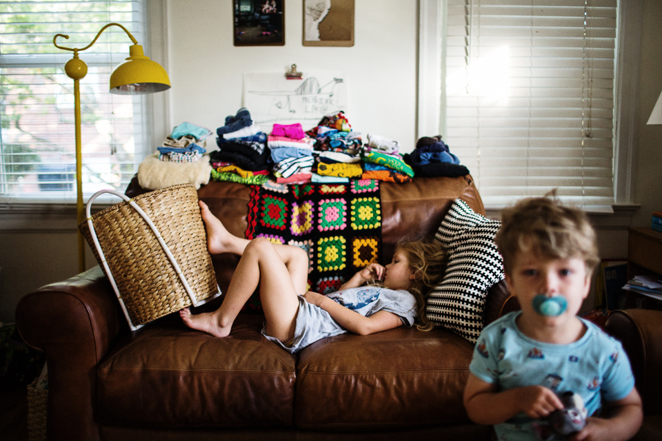 child sulks on couch