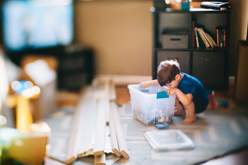 boy looking in toy tub - Family documentary photography