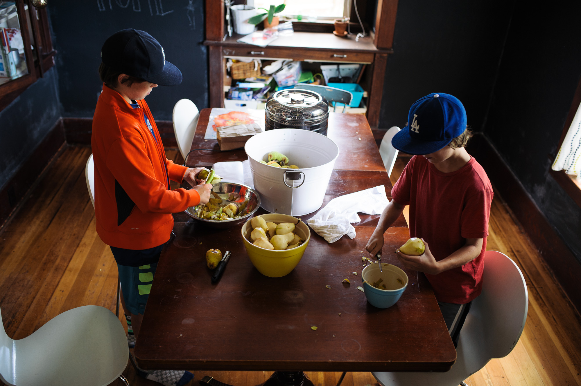 kids peel pears at dinner table - Family documentary photography