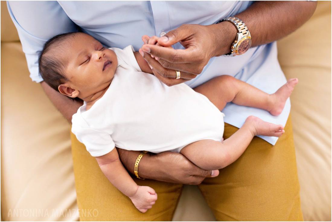baby sleeping in man's lap - Gold Hope Project