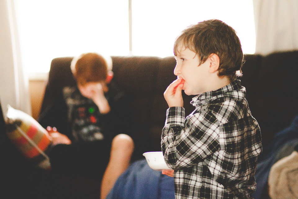 boy has snack on couch - family documentary photography 