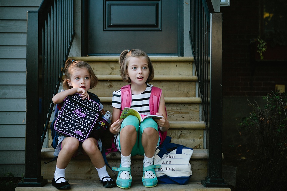 girls sitting on front stoop - Family documentary photography
