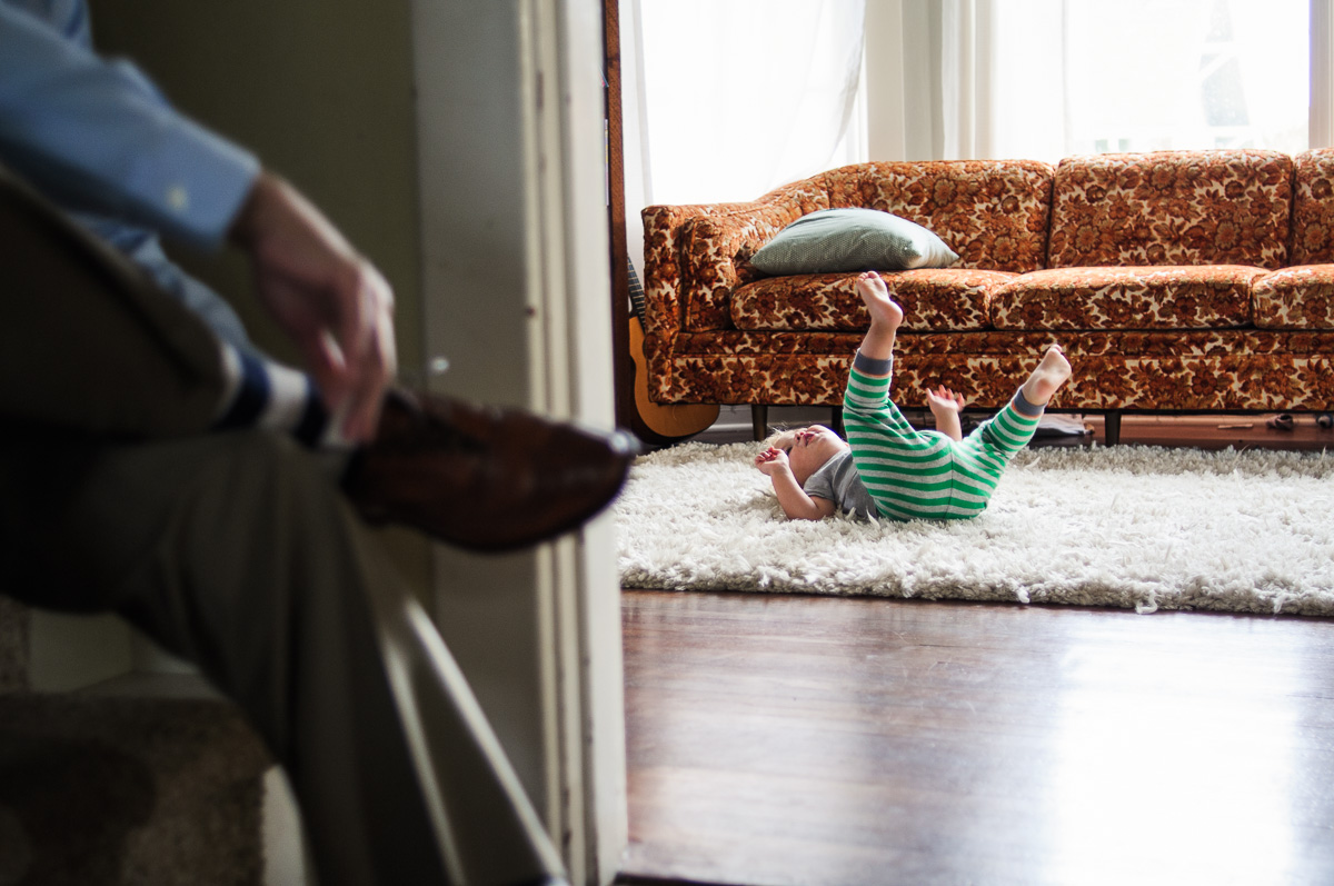 kid rolls around in pajamas in living room