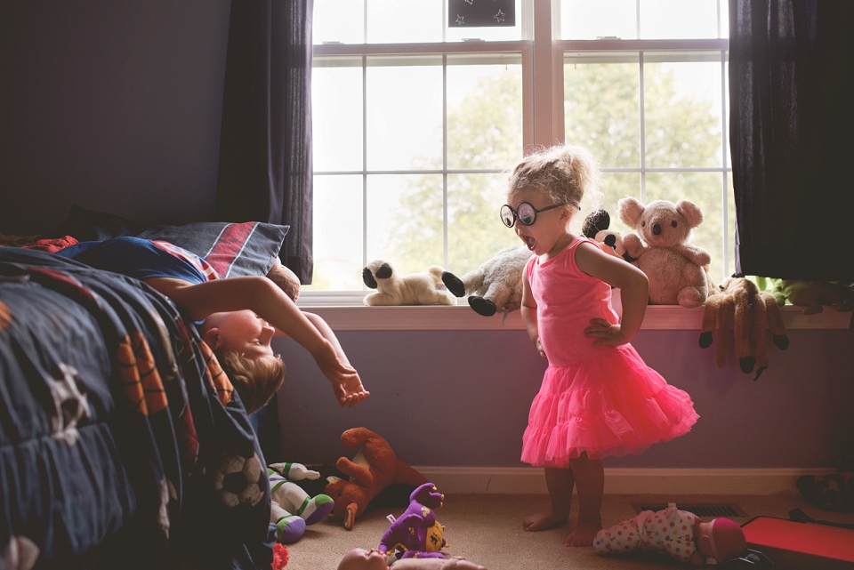 girl with joke glasses yelling at brother - family documentary photography