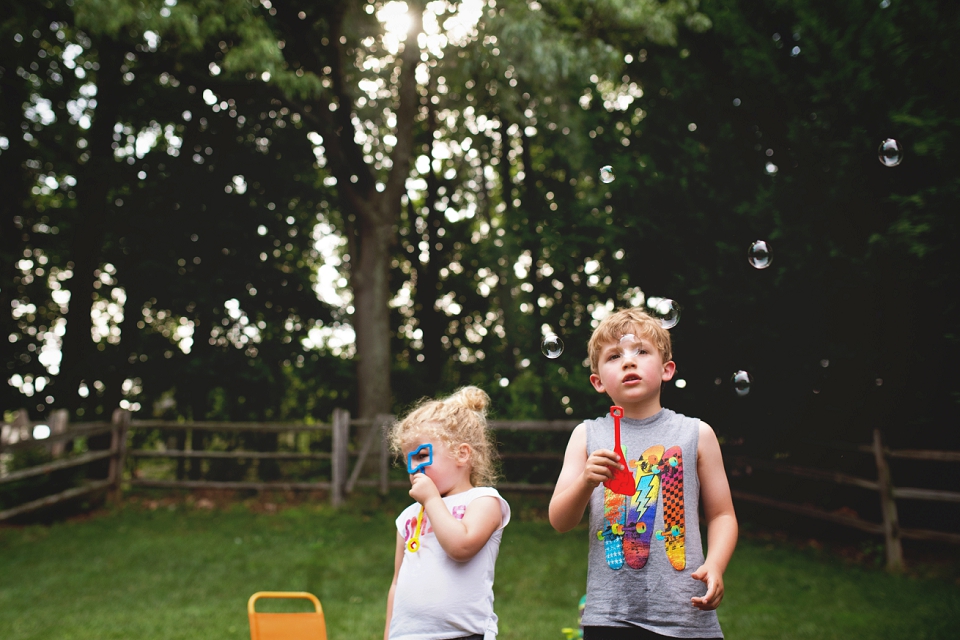 kids blowing bubbles - family documentary photography