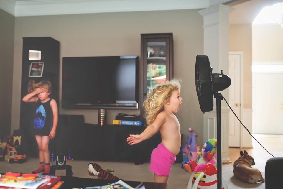 girl yelling into fan - family documentary photography