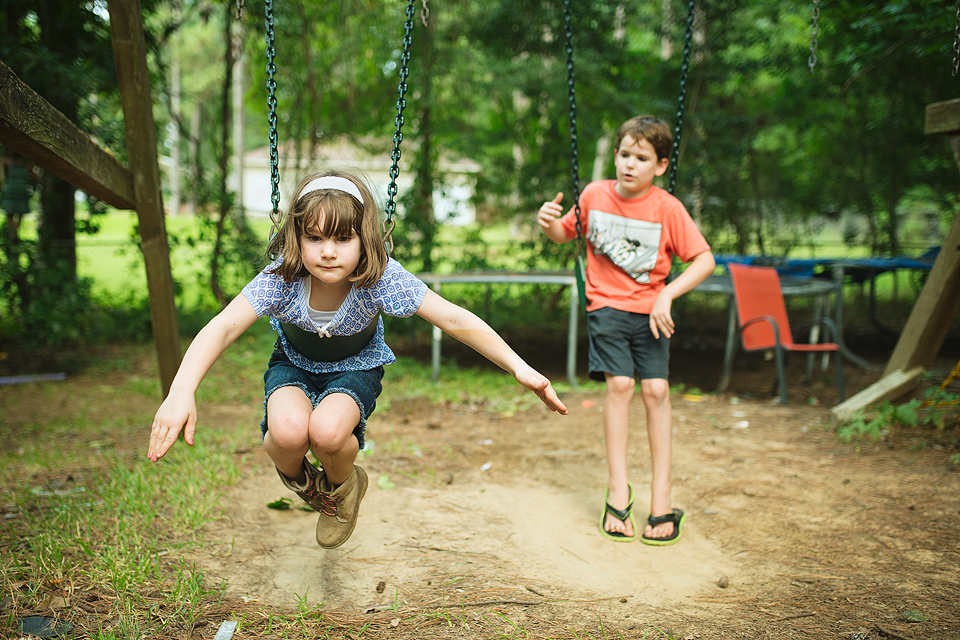 girl on swing as boy watches - Family Documentary Photography