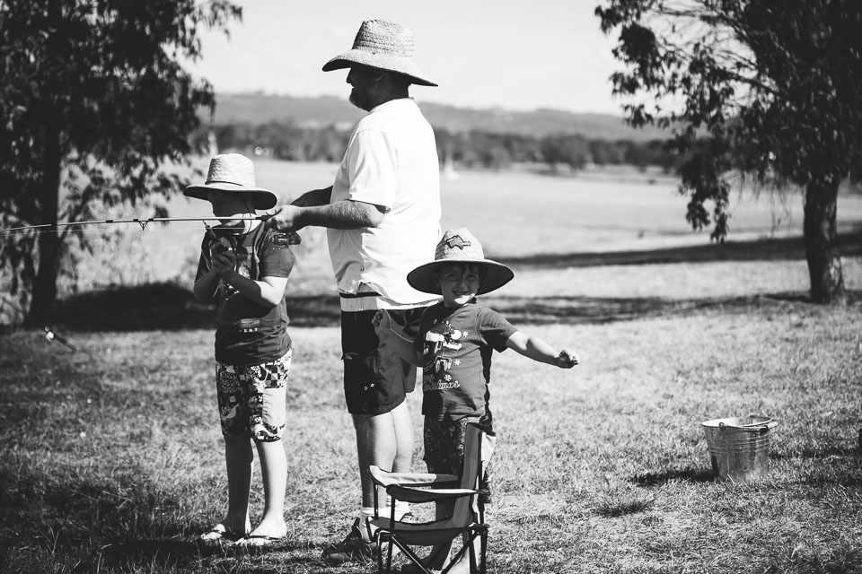 boys fishing with father - at the park