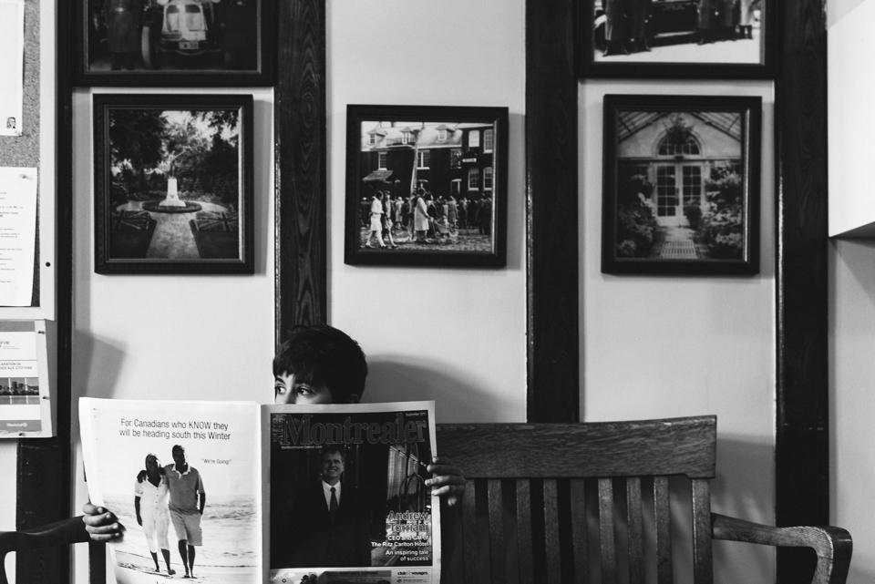 boy peering over magazine - Family Documentary Photography