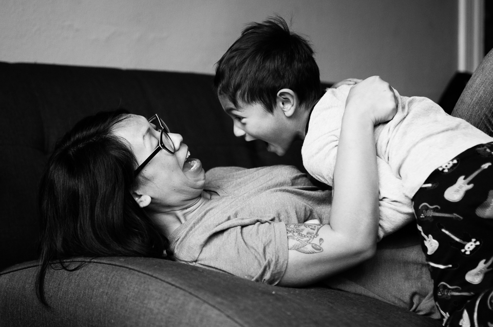 boy surprising mom - documentary family photography