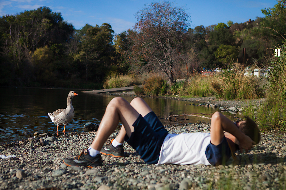 man laying on shore - at the park