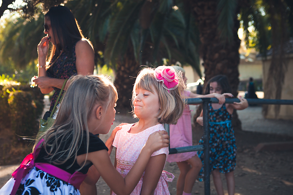 girls sharing a joke - documentary family photography