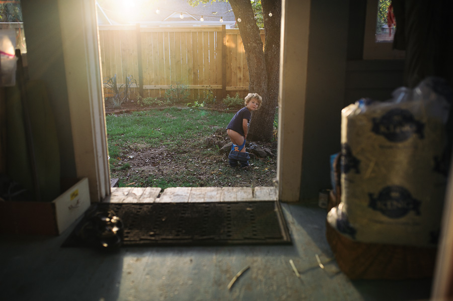 child peeing in back yard - documentary family photography