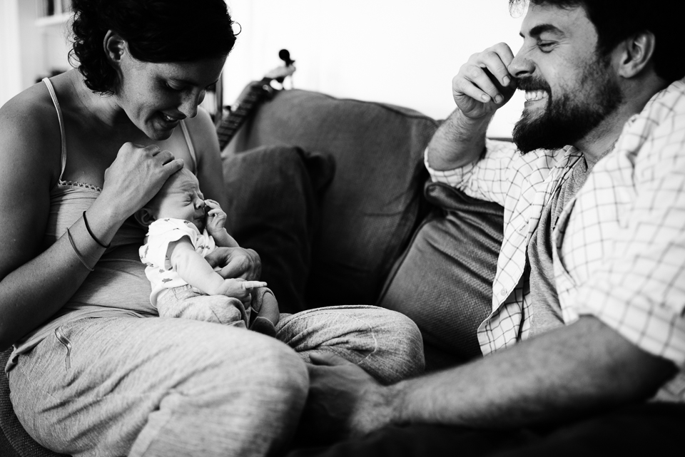 father mimics newborn - documentary family photography