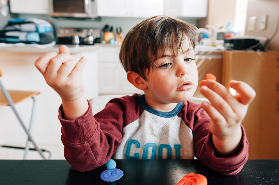 boy plays with play doh - documentary family photography