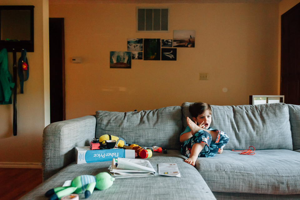 Boy on couch with toys - Family Documentary Photography
