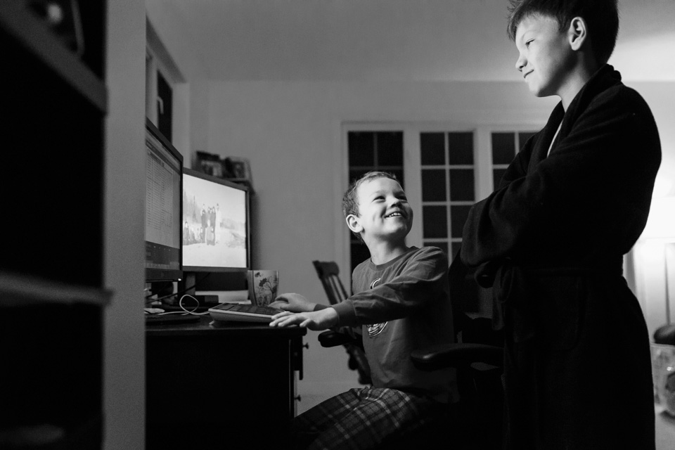boys laughing at computer - documentary family photography
