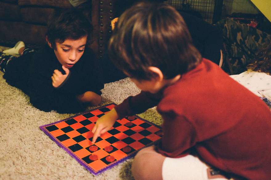 kids play checkers - documentary family photography
