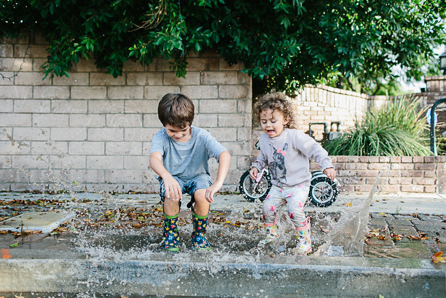 kids splash in puddle - Family Documentary Photography