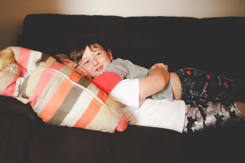 boy snuggles with brother - family documentary photography