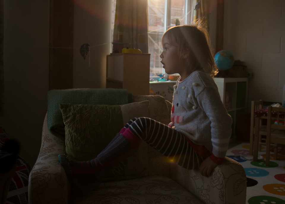 girl on chair with sun flare - Family Documentary Photography
