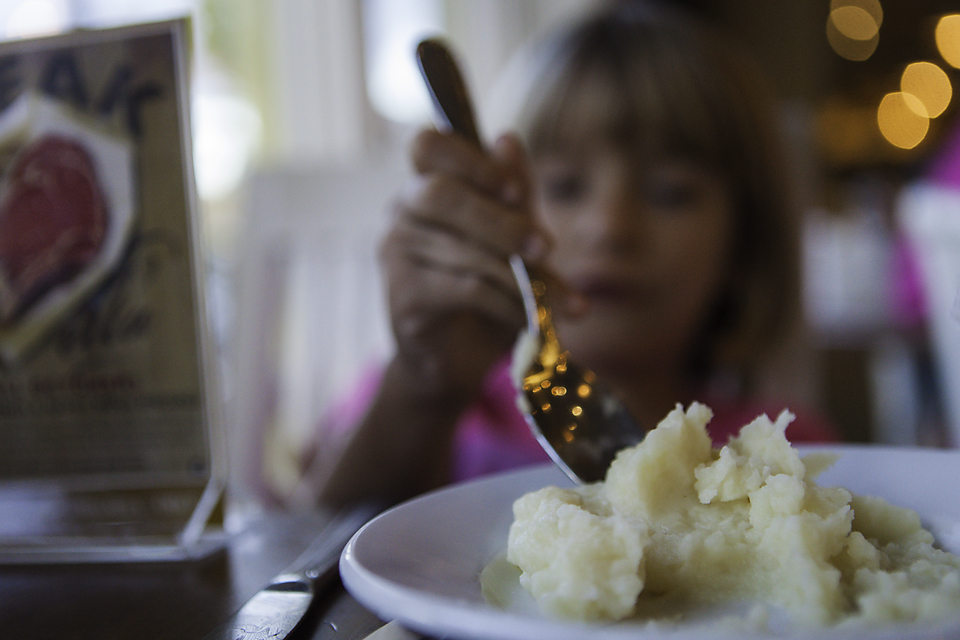 girl eating mashed potatoes - family documentary photography