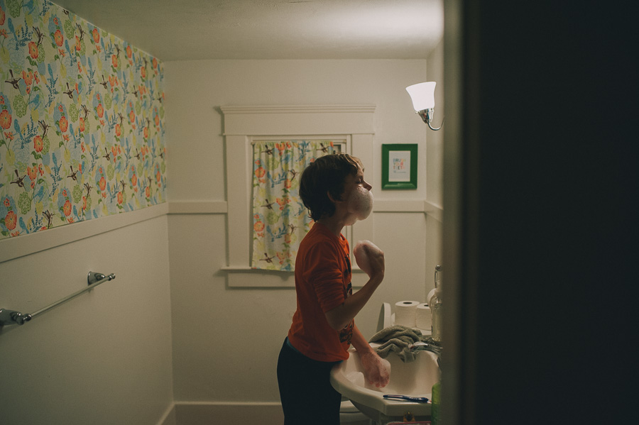 boy shaving his face with bubbles