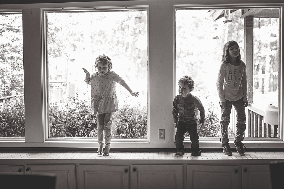 Kids jumping in bay window - Family Documentary Photography