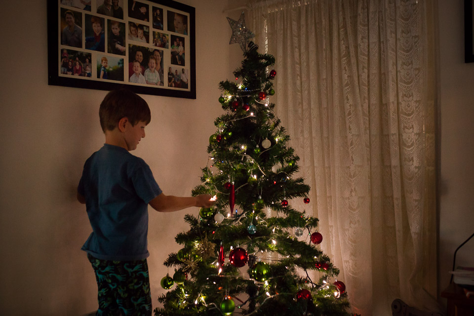 boy at Christmas tree - Family Documentary Photography