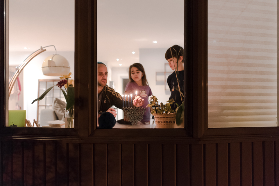 Family lighting menorah - Family Documentary Photography