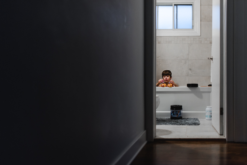 Kid in bathtub from doorway - Family Documentary Photography