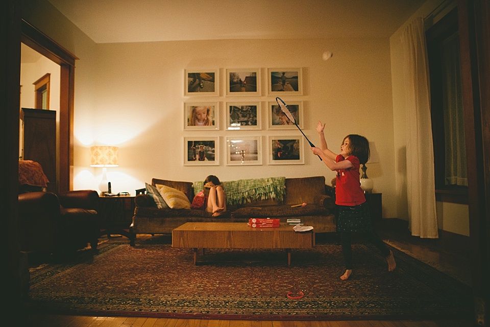 girl with racquet in living room - Family Documentary Photography