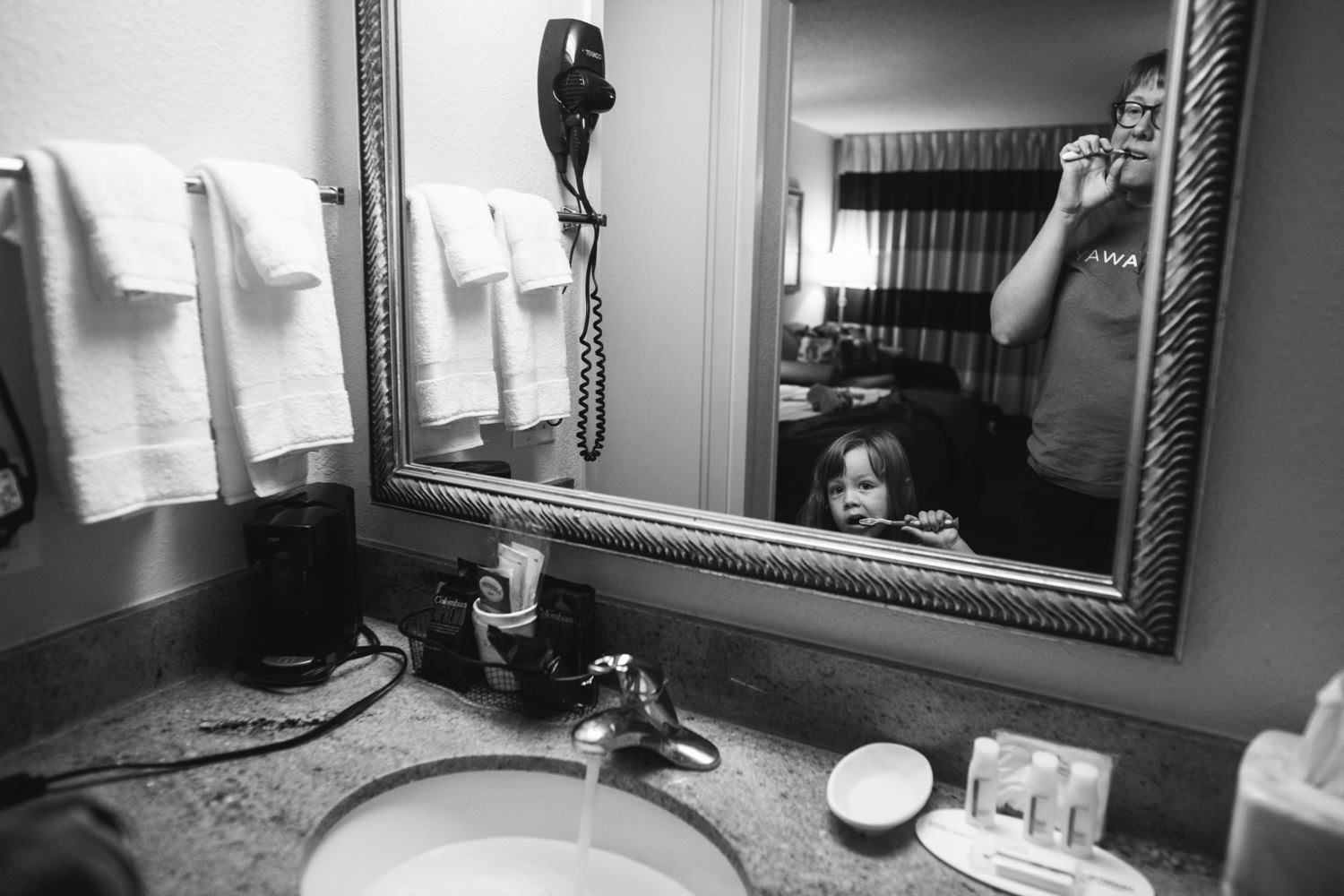 Mother and daughter brush teeth 