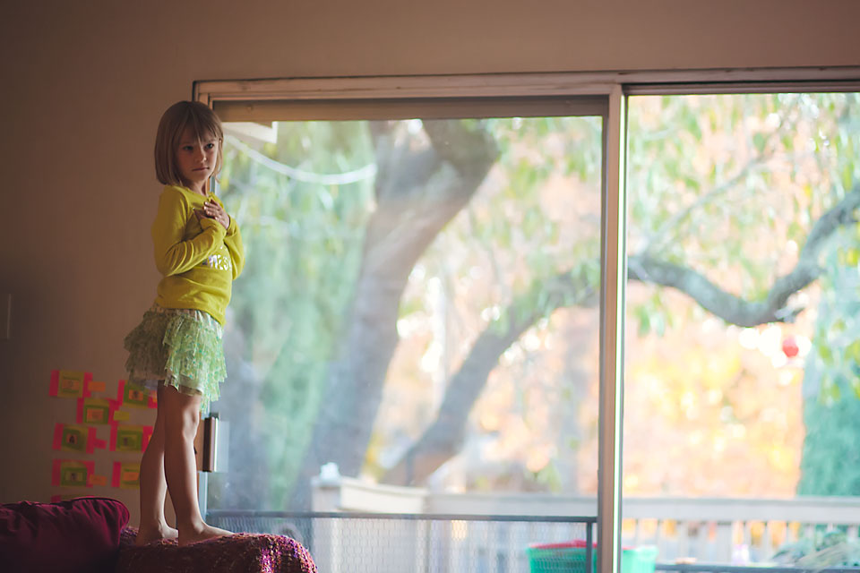 Girl standing at window- Family Documentary Photography