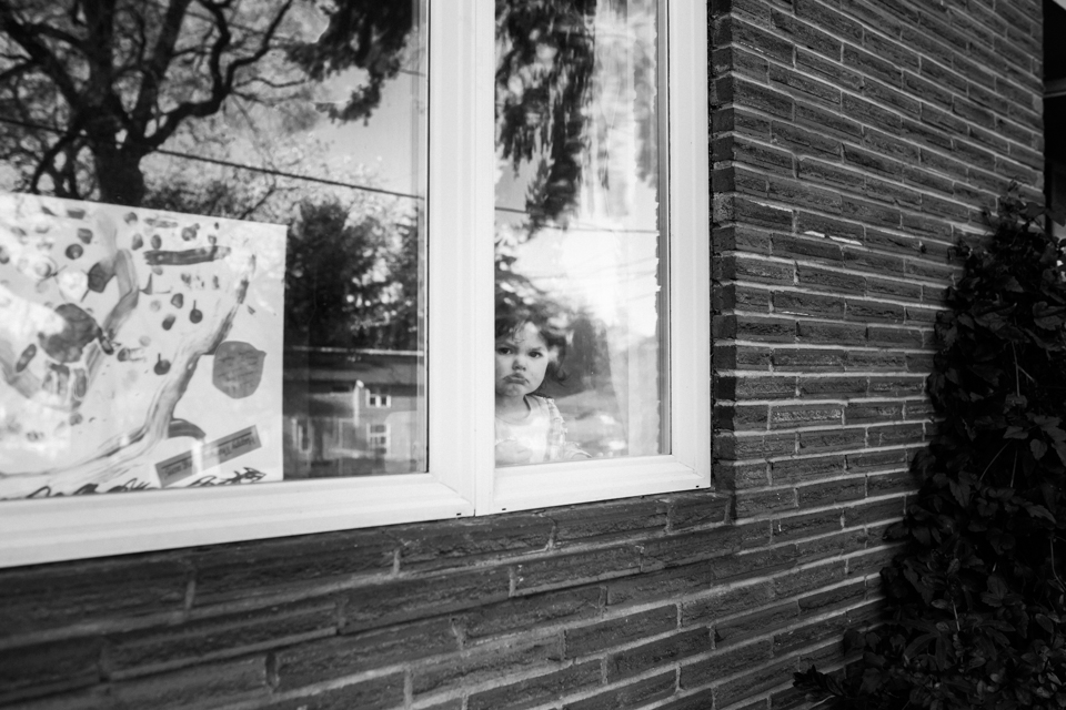 Girl pouting through window - Family Documentary Photography