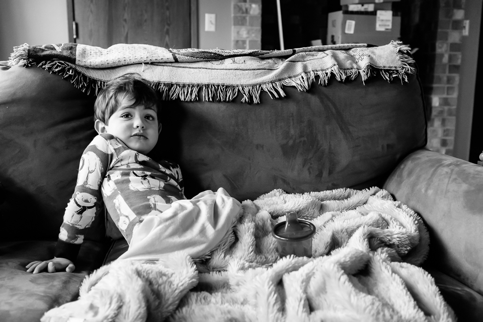 boy lounges on couch - Family Documentary Photography
