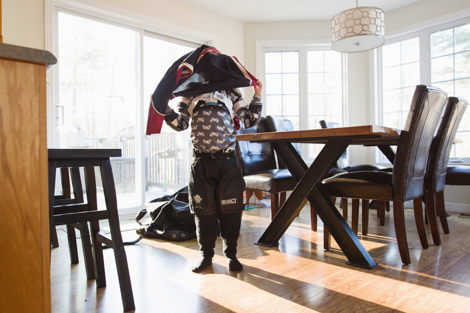 boy putting on snow gear - Family Documentary Photography