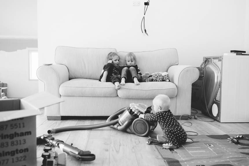 boys play with tablet baby plays with vaccum - Family Documentary Photography