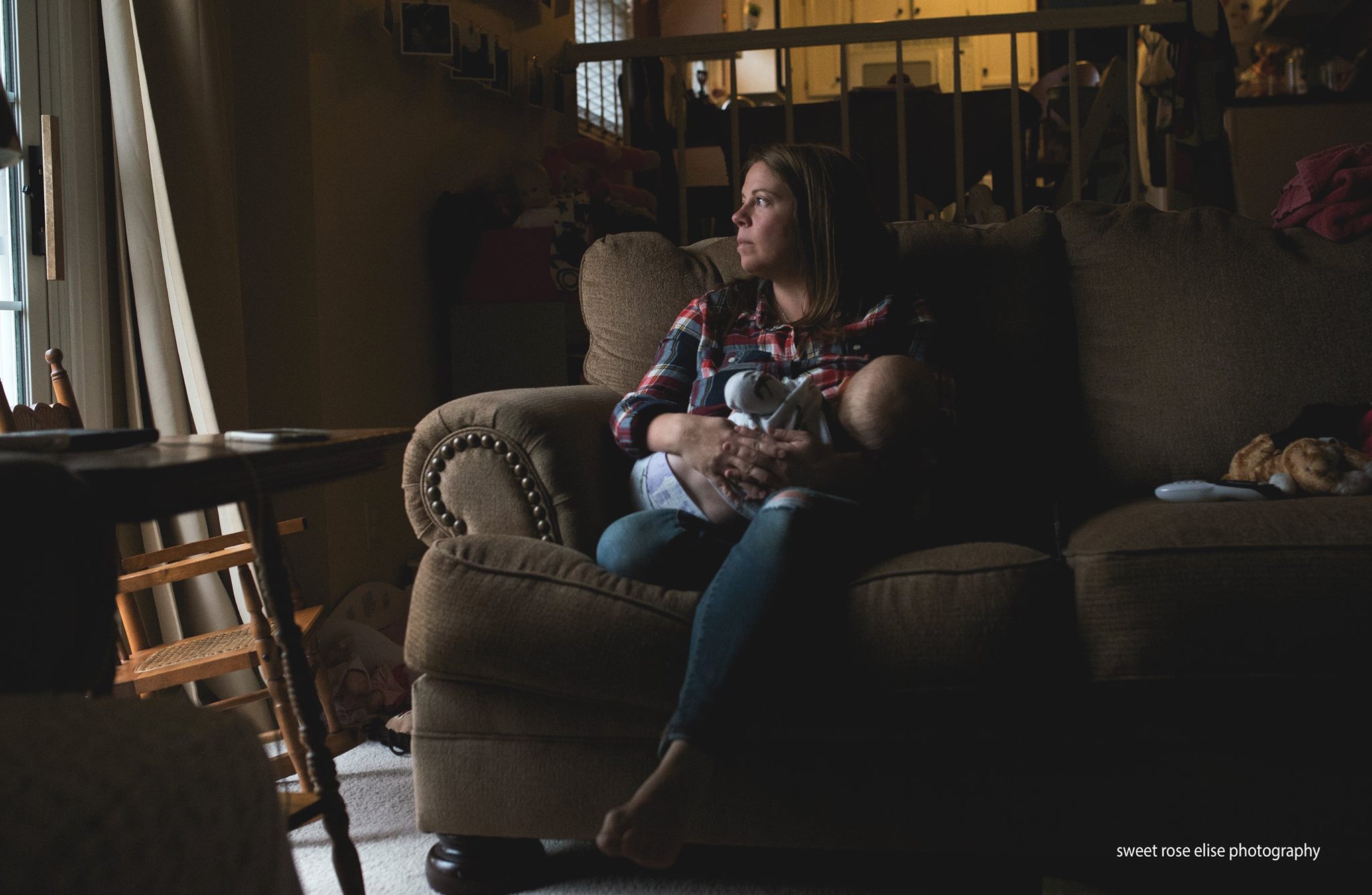 woman nurses on chair in window light