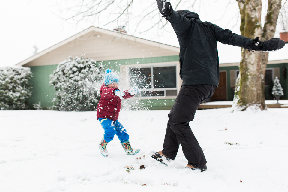 child and parent playing in snow -Documentary Family Photography