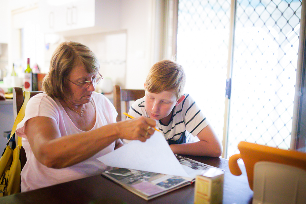 grandmother helps with homework - Documentary Family Photography
