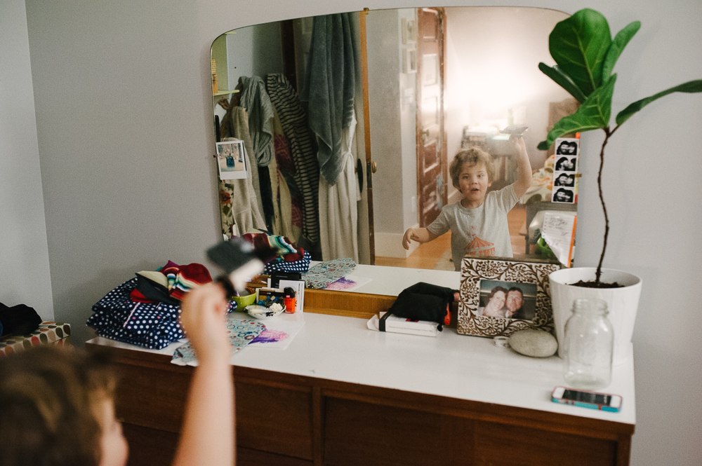 boy playing in mirror - Documentary Family Photography